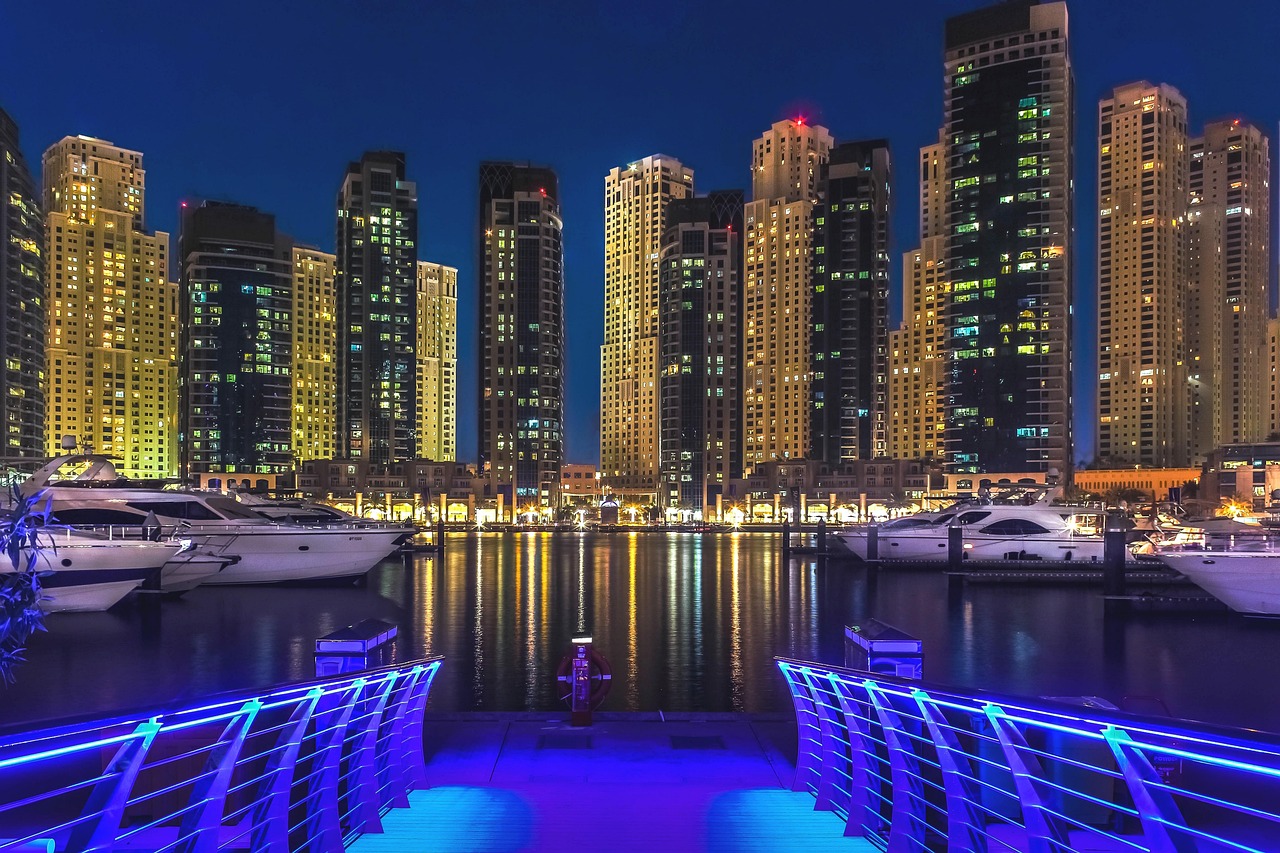 Dubai Marina towers and yachts at blue hour