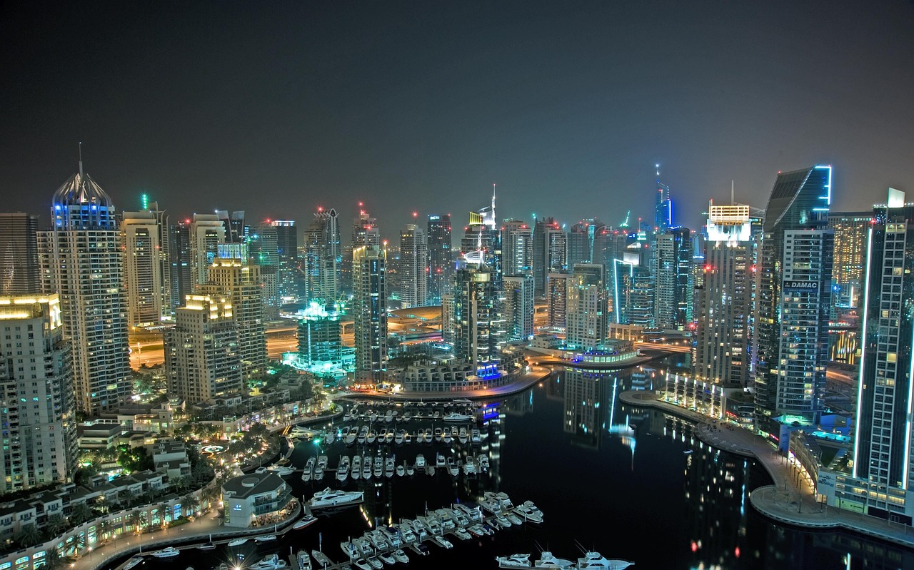 Dubai Marina towers and yachts lit at night